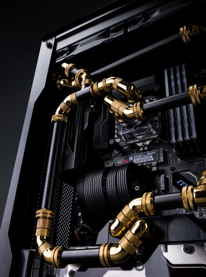 Black and gold fittings and tubing in a Maingear F131